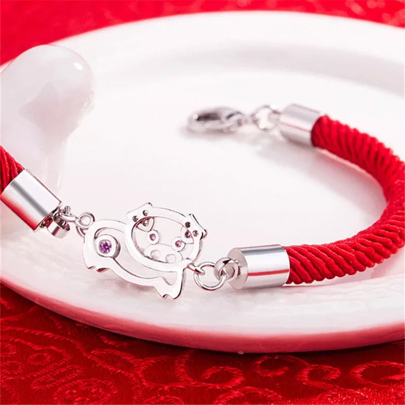 BRAZALETE CERDITO DE LA SUERTE TEJIDO