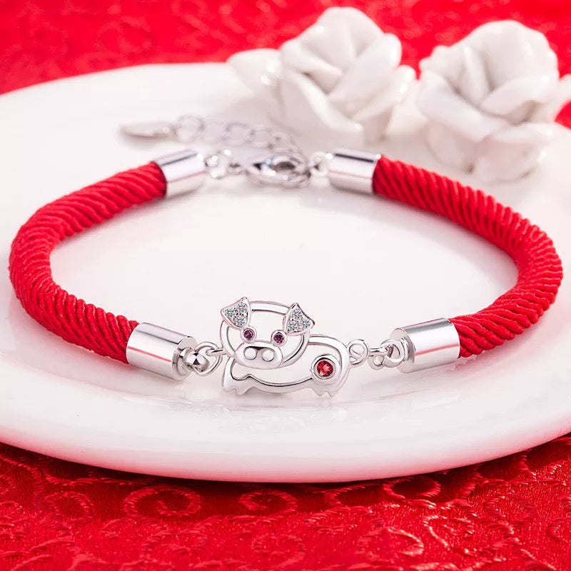 BRAZALETE CERDITO DE LA SUERTE TEJIDO
